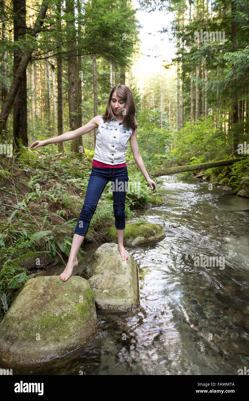 Teenage girl walking barefoot over rocks in a stream Chilliwack British Columbia Canada Stock Photo Alamy
