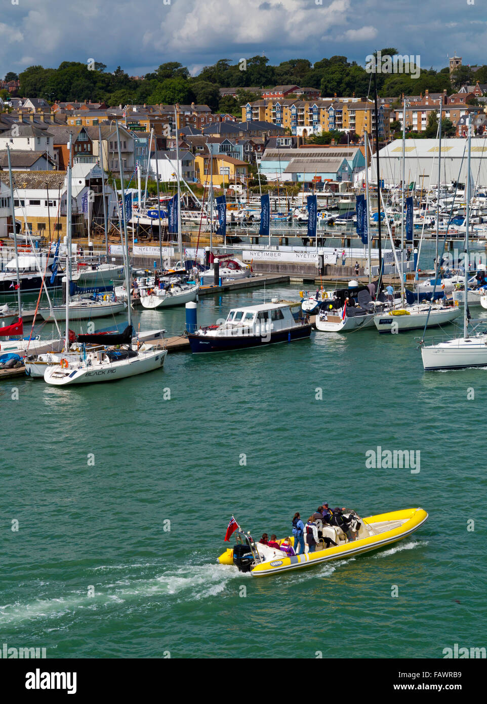 Sailing boats and the harbour at Cowes during Cowes Week a regatta held every August on the Isle of Wight southern England UK Stock Photo