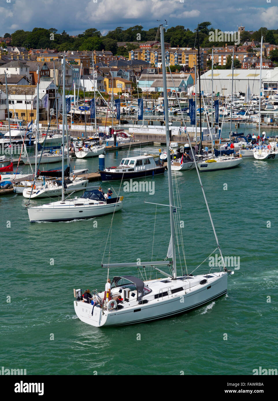 Sailing boats and the harbour at Cowes during Cowes Week a regatta held every August on the Isle of Wight southern England UK Stock Photo
