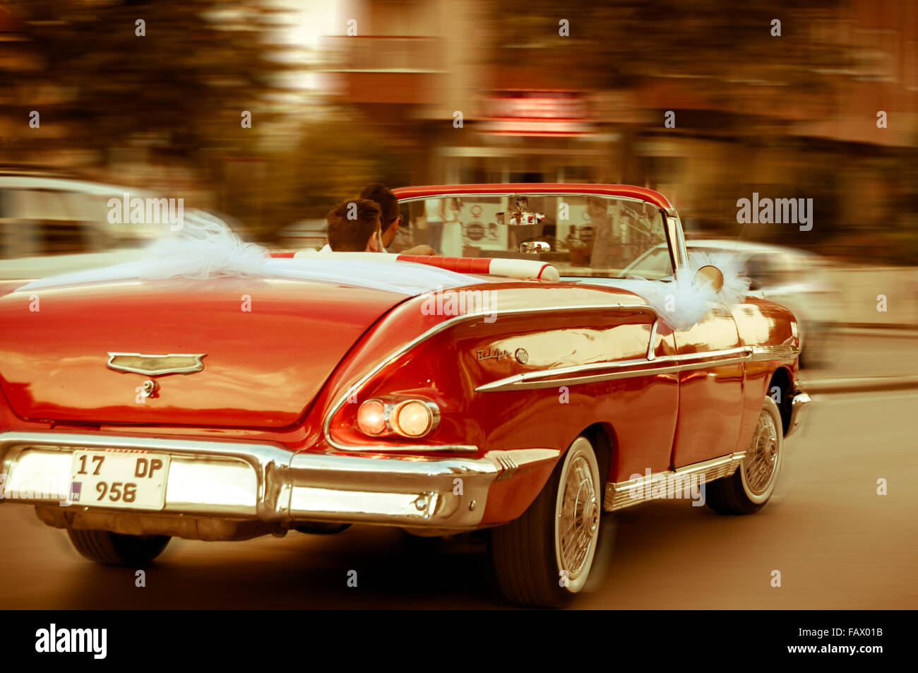 Red retro Oldtimer driving on street with motion blur Stock Photo