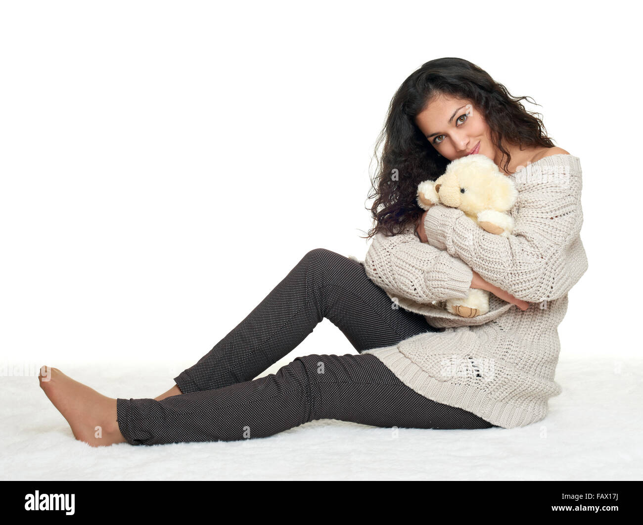 beautiful young girl sit on floor, white background Stock Photo - Alamy