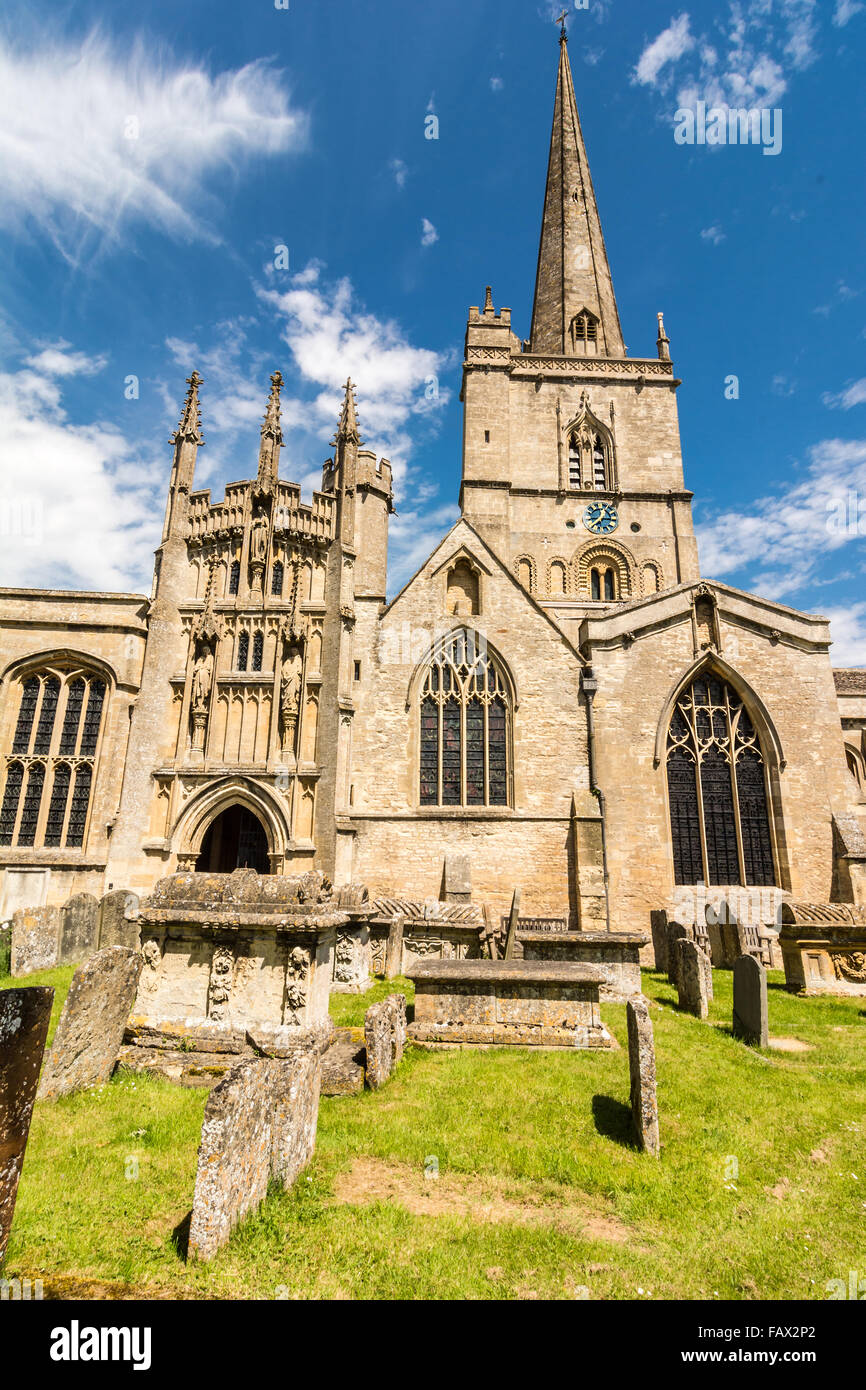 St John the Baptist church with old gravestones in the foreground, Burford, Oxfordshire, England, UK, Western Europe. Stock Photo
