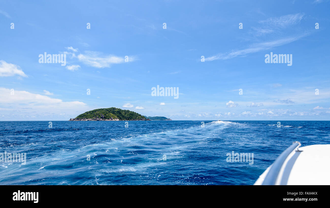 Travel by speed boat to islands in the beautiful landscape of blue sea and sky during summer at Mu Ko Similan National Park, Stock Photo