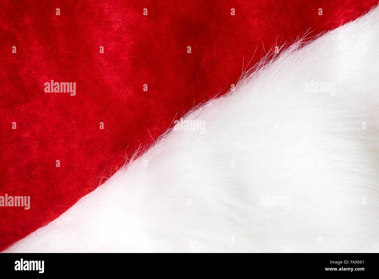 Front part of Santa Clause red and white hat as diagonal background. Stock Photo