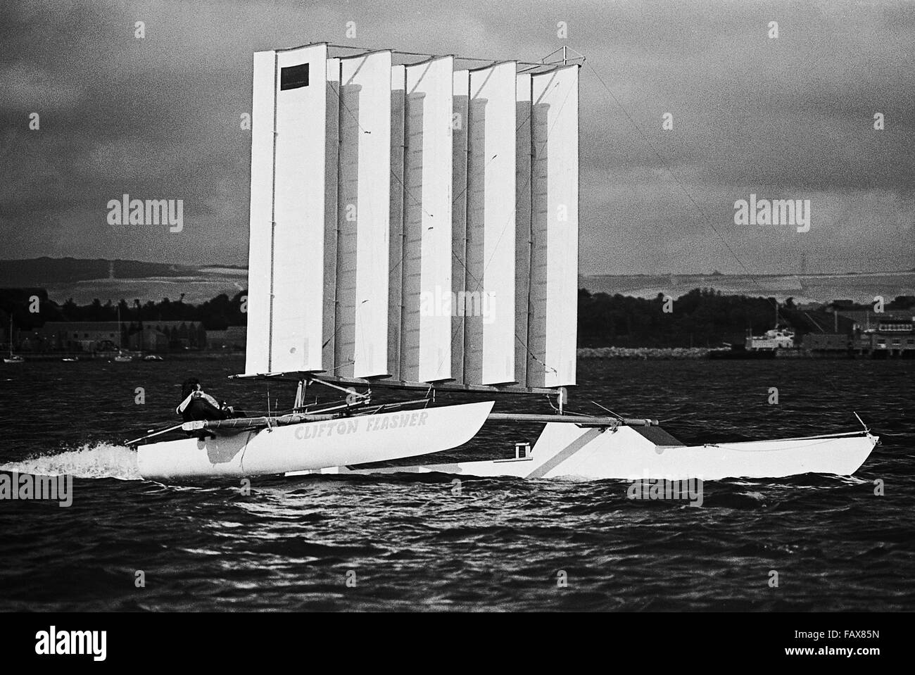 AJAXNETPHPOTO. - 29TH OCT, 1976. PORTLAND, ENGLAND. - PLANE SAILING - THE AEROFOIL RIGGED MULTIHULL CLIFTON FLASHER AT SPEED. PHOTO:JONATHAN EASTLAND/AJAX REF:7629101 25186 Stock Photo