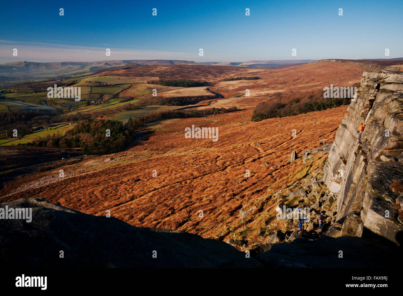 Stanage Edge Rocks Rock climbers on Stanage Edge during a bright but cold winters day in ...