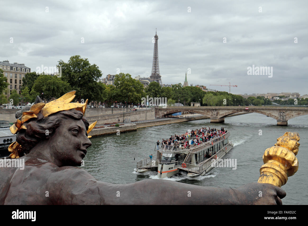 A tourist boat on the River Seine oassing under the Pont Alexandre III in Paris, France. Stock Photo