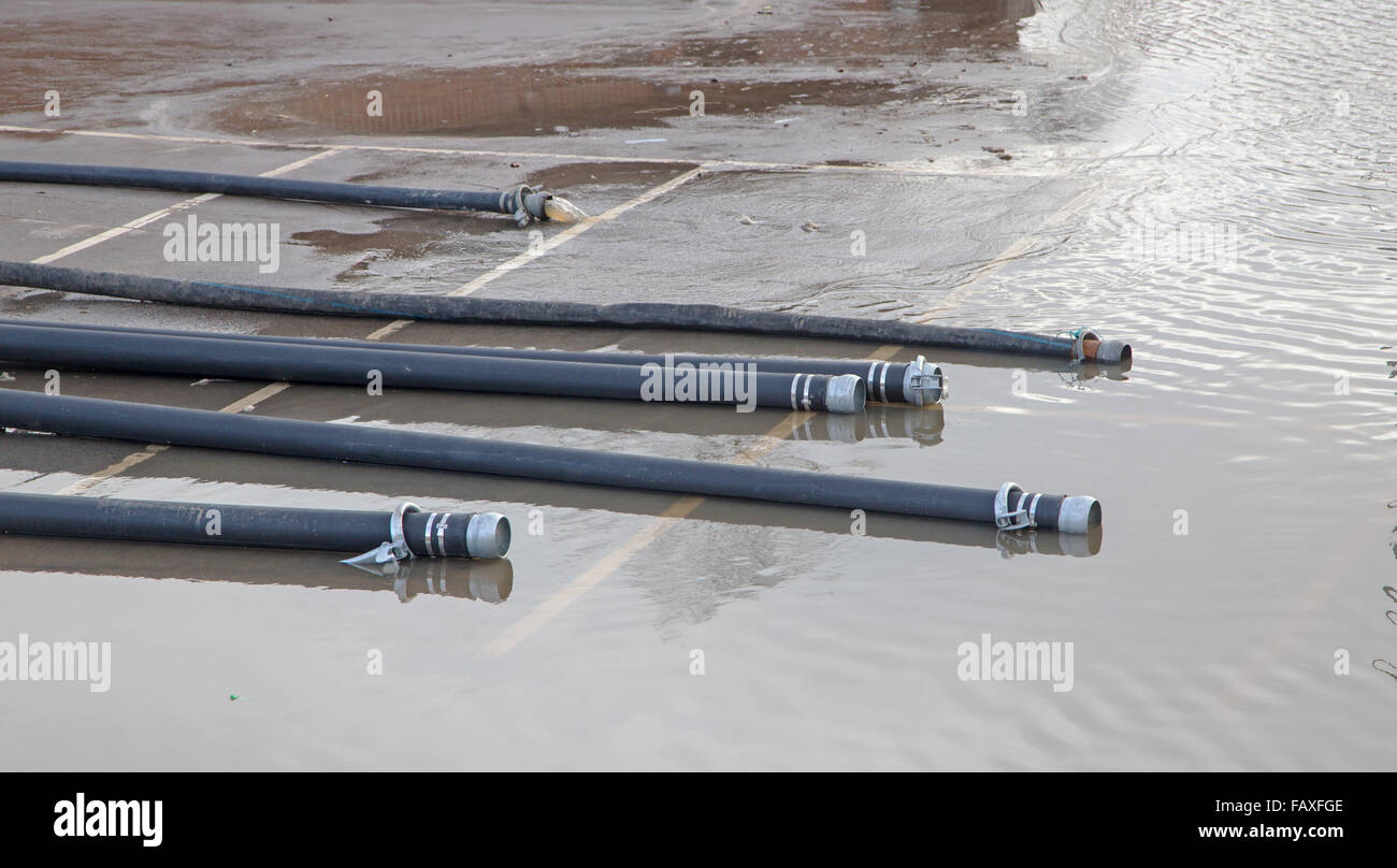 Fire Brigade hose pipes used for pumping flood water out of flooded houses Stock Photo