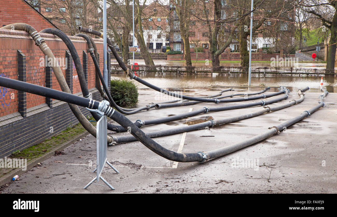 Fire Brigade hose pipes used for pumping flood water out of flooded houses Stock Photo