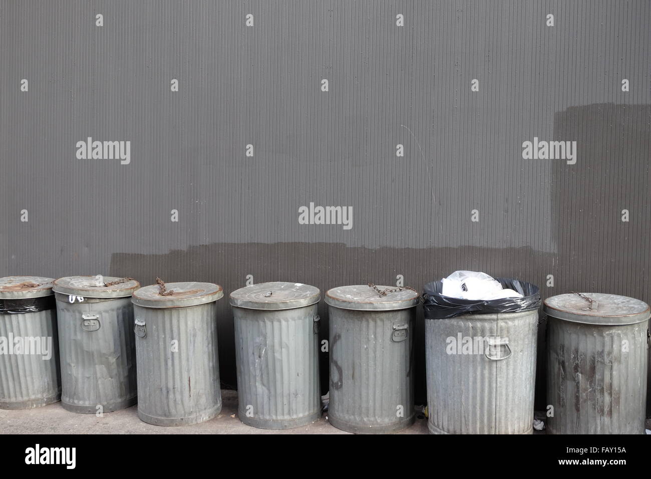 trash cans line the street in chinatown, new york city photo by jen