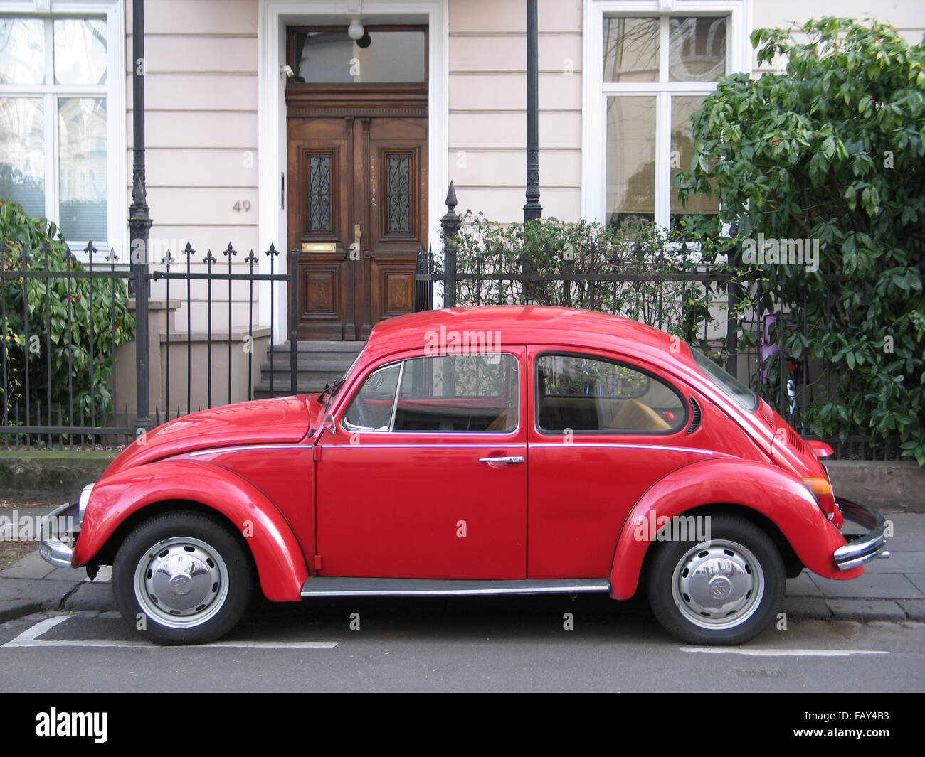 Red VW 'Käfer' car parking on the street Stock Photo