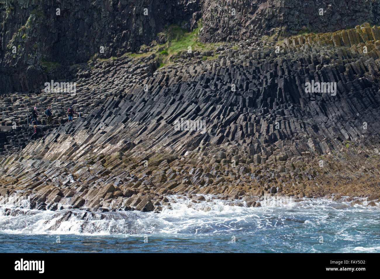 Basalt hexagonal pillars or columns, exposed just above tidal waves of sea water. Alongside Fingel's Cave. Staffa. Scotland. Stock Photo