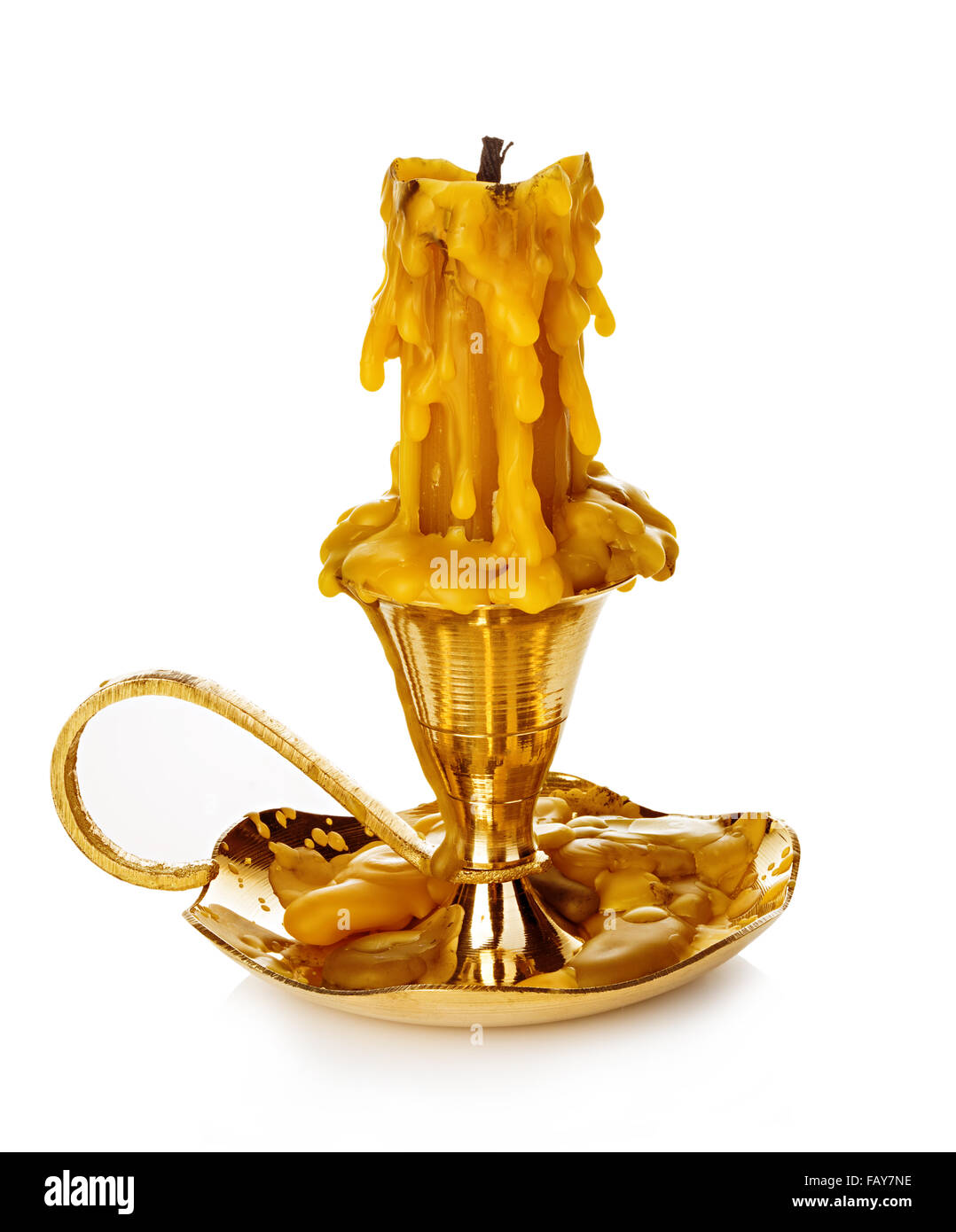 Burning vintage church candle wax in old gold candlestick isolated on