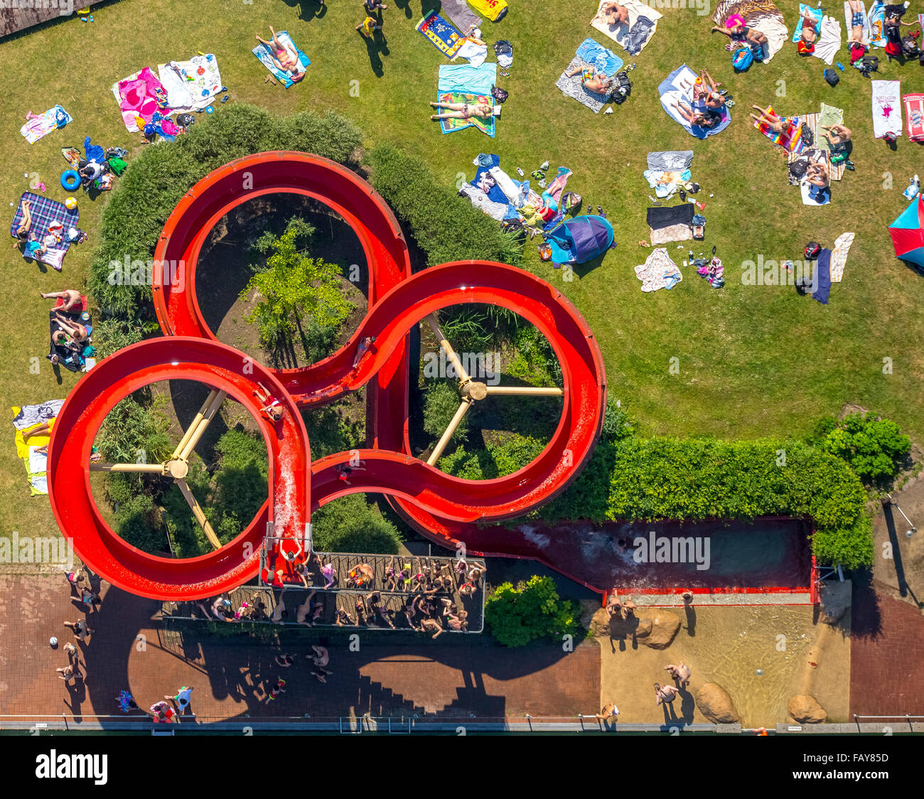 Aerial view, aerial view, natural pool Styrum with Naturbad concept, red water slide, lawn, beach towels, summer feeling, Stock Photo