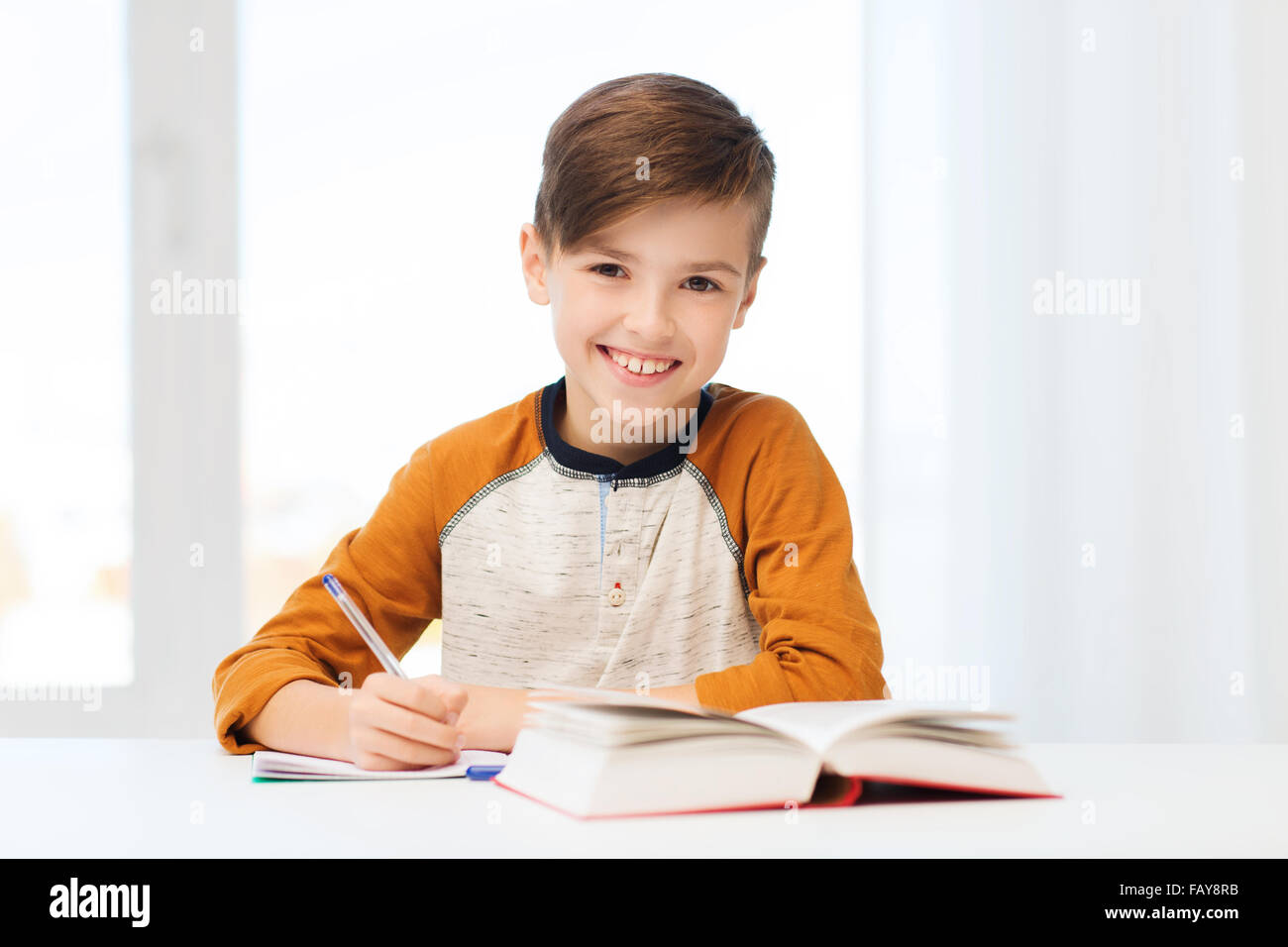 Smiling Teenage Boy Sunglasses Taking Notes Looking Away While Studying  Stock Photo by ©ArturVerkhovetskiy 203552762