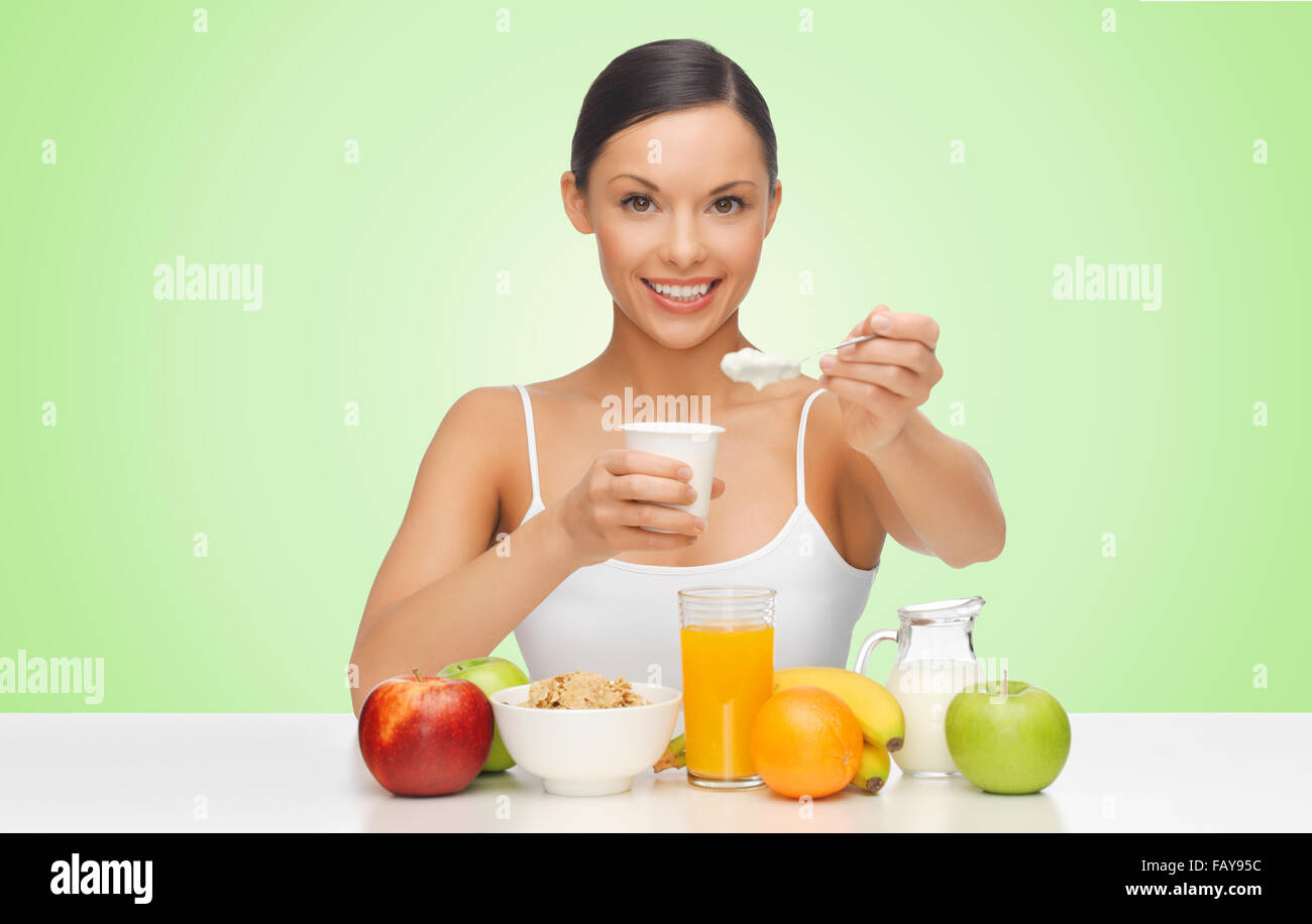 happy woman eating yogurt for breakfast Stock Photo Alamy