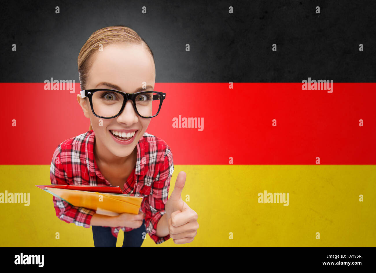 happy student girl with folders showing thumbs up Stock Photo - Alamy