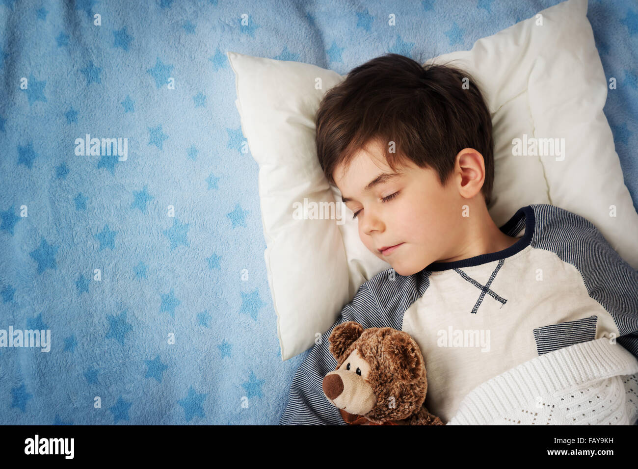 six years old child sleeping in bed with alarm clock Stock Photo Alamy