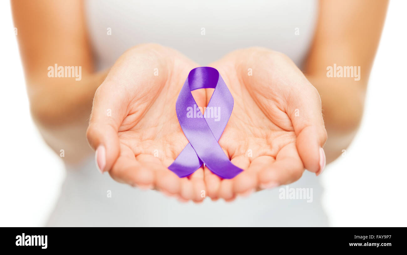 hands holding purple awareness ribbon Stock Photo