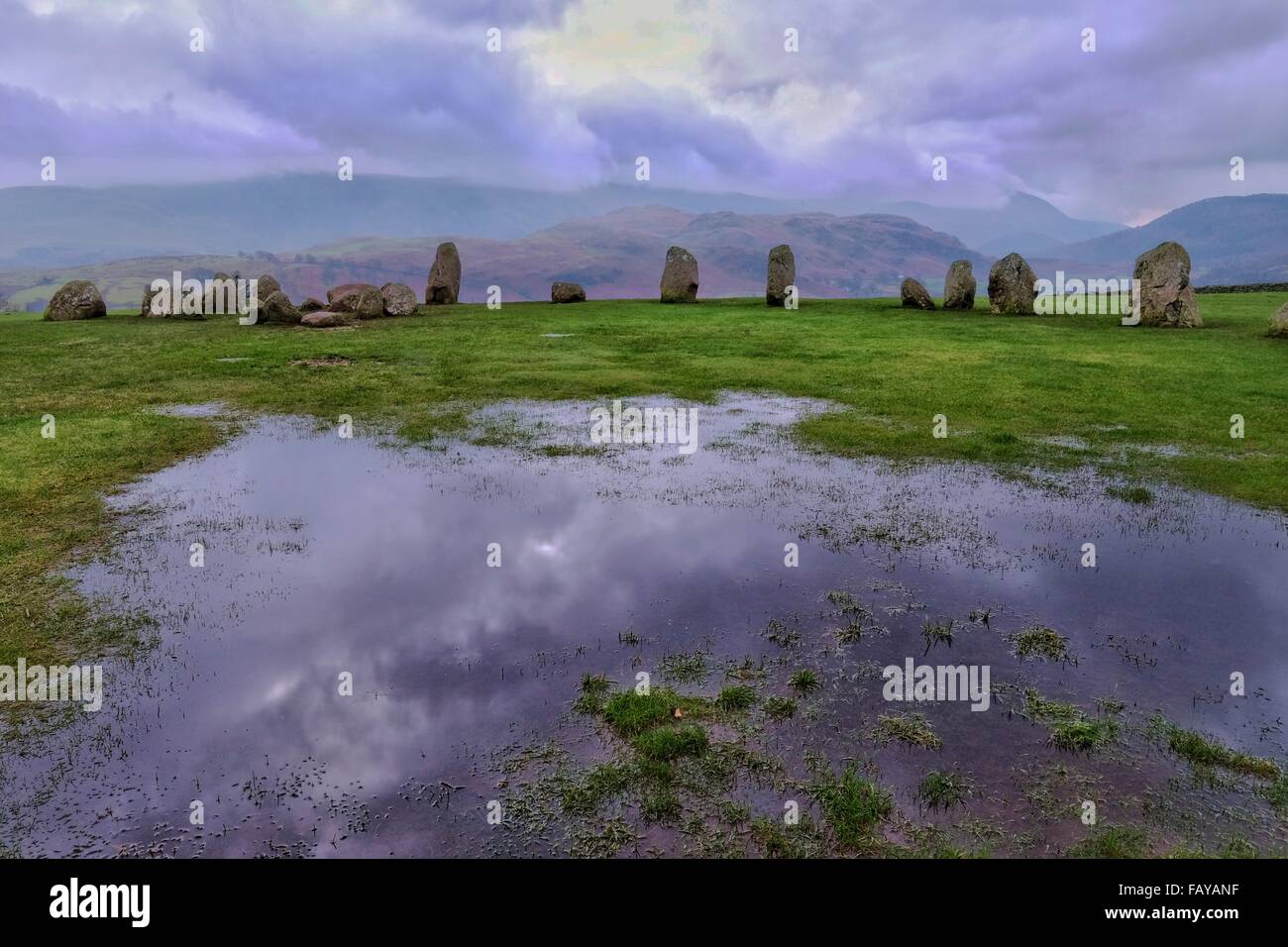 Castlerigg Stone Circle, Keswick, Cumbria, UK. 6 January 2016. Heavy skies and waterlogged ground mark the start of the day at Castlerigg Stone Circle. The site described by archaeologist John Waterhouse as 'one of the most visually impressive prehistoric monuments in Britain' sits above the Keswick where flooding is still expected. Credit:  Tom Corban/Alamy Live News Stock Photo