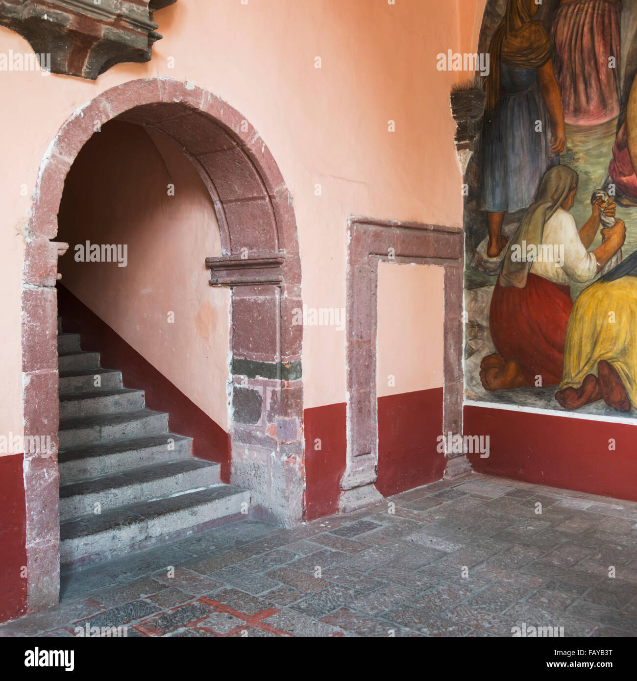 Mural painted on a wall beside steps under an arch; San Miguel de Allende, Guanajuato, Mexico Stock Photo