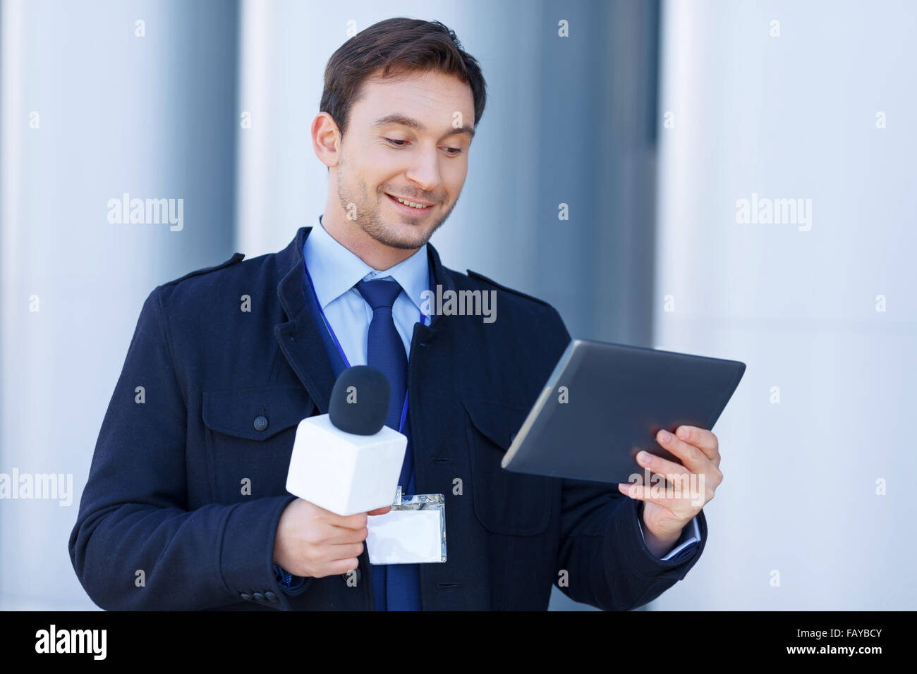 Newshawk is amused by information on his tablet. Stock Photo