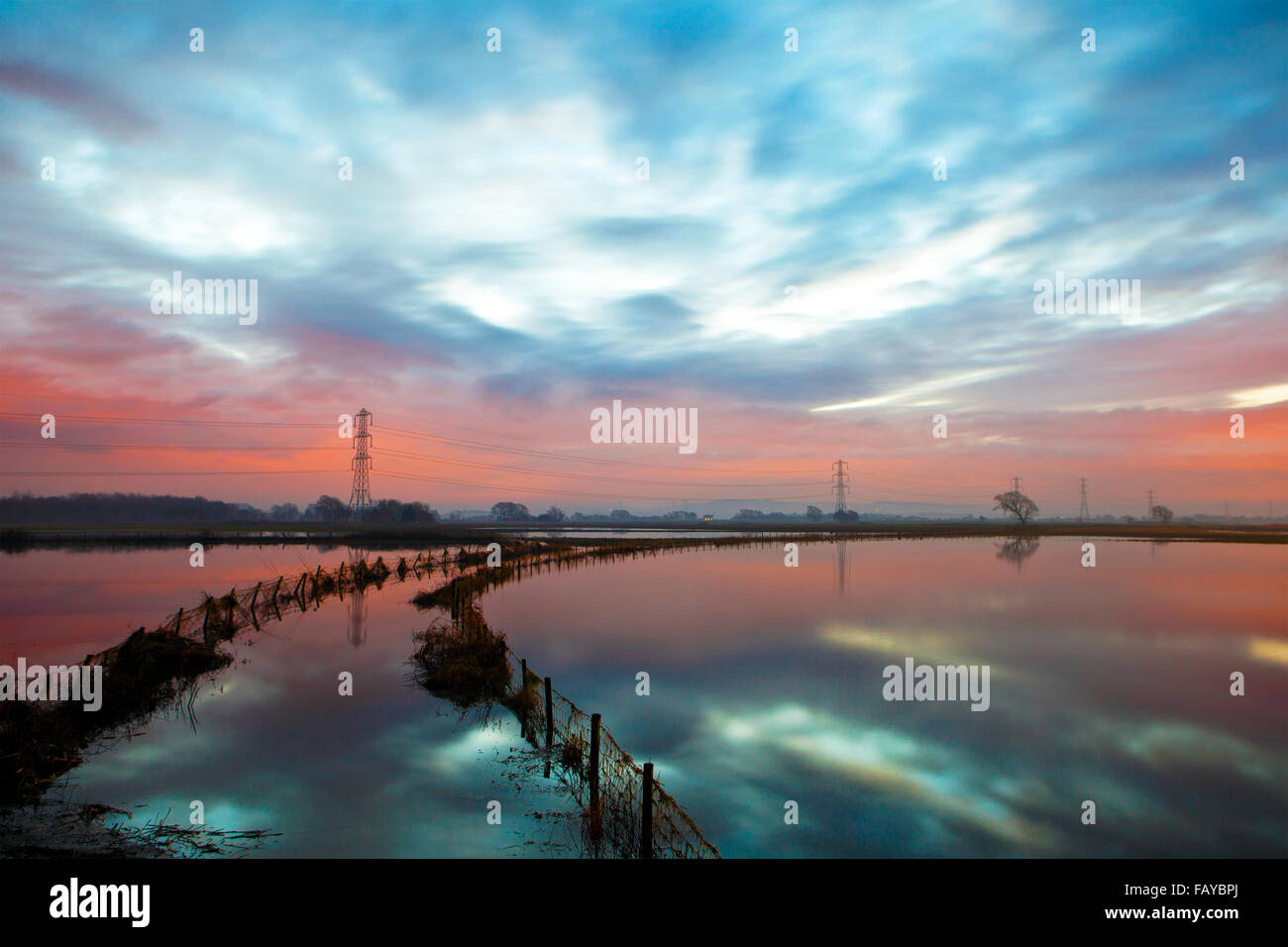 Croston, Lancashire, UK. 6th Jan, 2015. The water is now tranquil & still. The soup of mud and debris washes away the hopes of our Lancashire farmers. Now the sky is clear, the air merely moist, but the water recedes stealing the fertilizers and the seeds along with it. Credit:  Cernan Elias/Alamy Live News Stock Photo