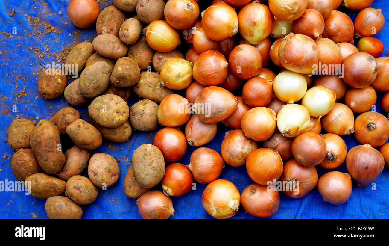 Potatoes and onions in a food market at which local farmers sell