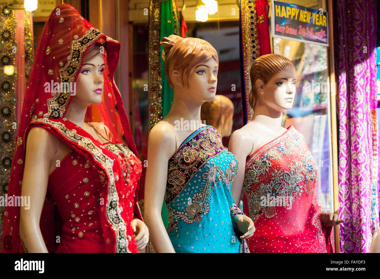 Three mannequins dressed in colourful, embroidered Saris outside a shop in India Stock Photo