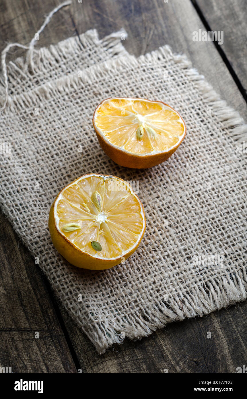 dried  lemon  slices on rusty dark wooden table, close up Stock Photo
