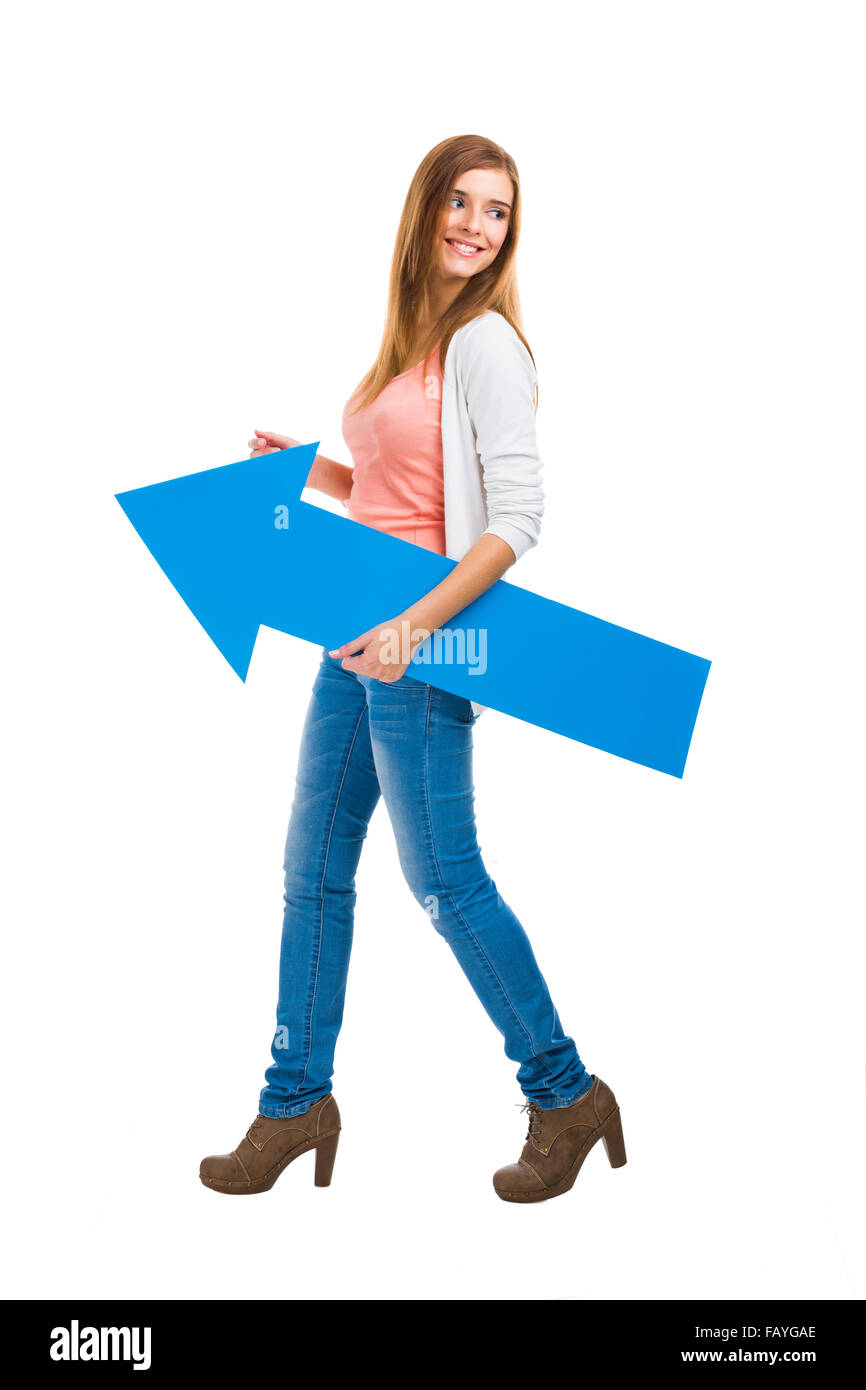 Beautiful woman walking while holding a blue arrow Stock Photo - Alamy