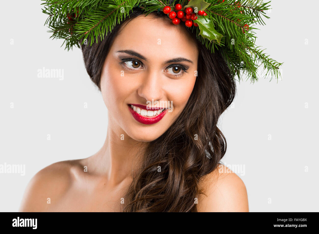 Portrait of a beautiful woman with Cristmas decorations on the head Stock Photo