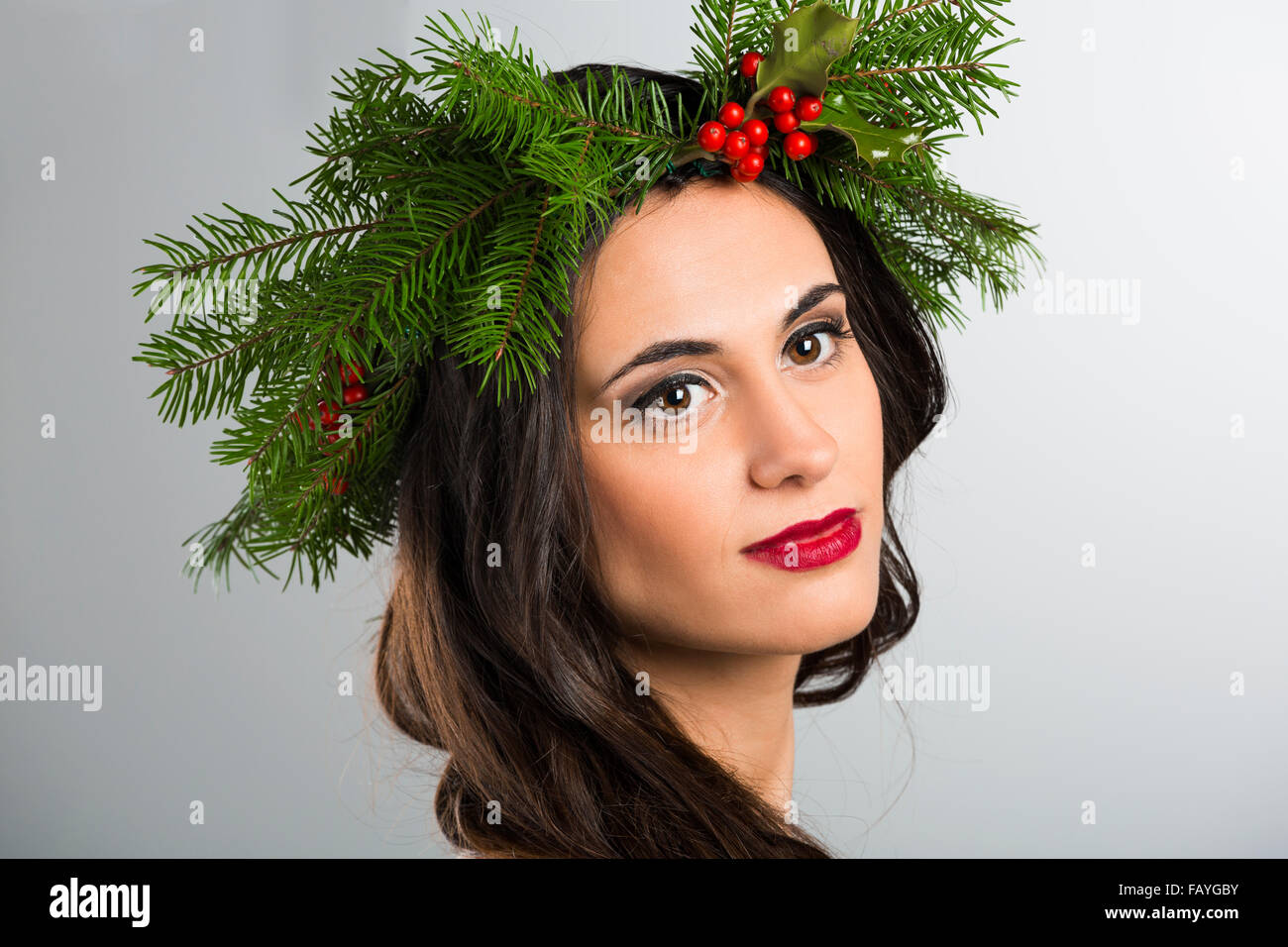 Portrait of a beautiful woman with Cristmas decorations on the head Stock Photo