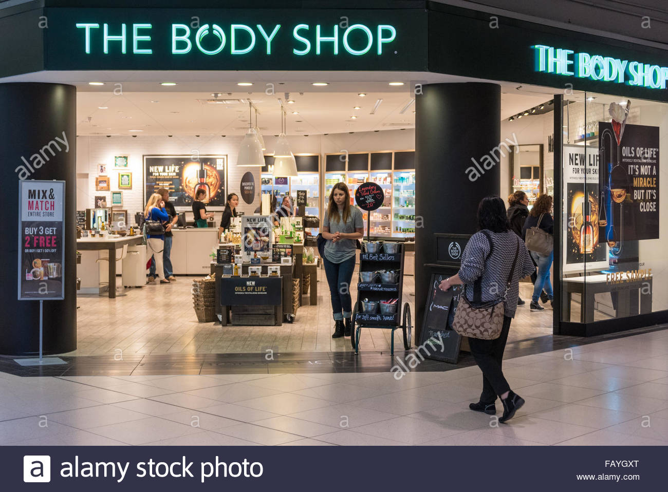 The Body Shop store front view in mall. People Shopping at the body