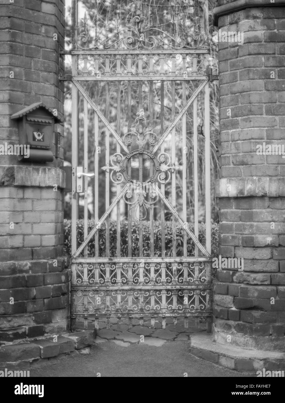 Old worn out ornamental iron gate Stock Photo