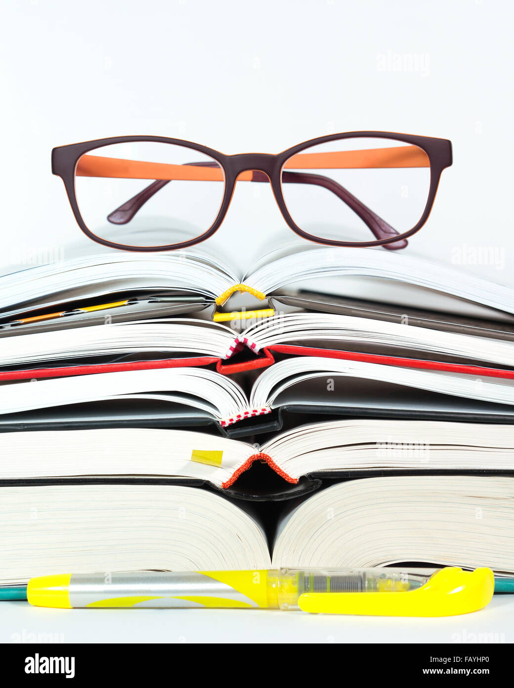 Open book stack with reading eyeglasses and marker pen for study and ...