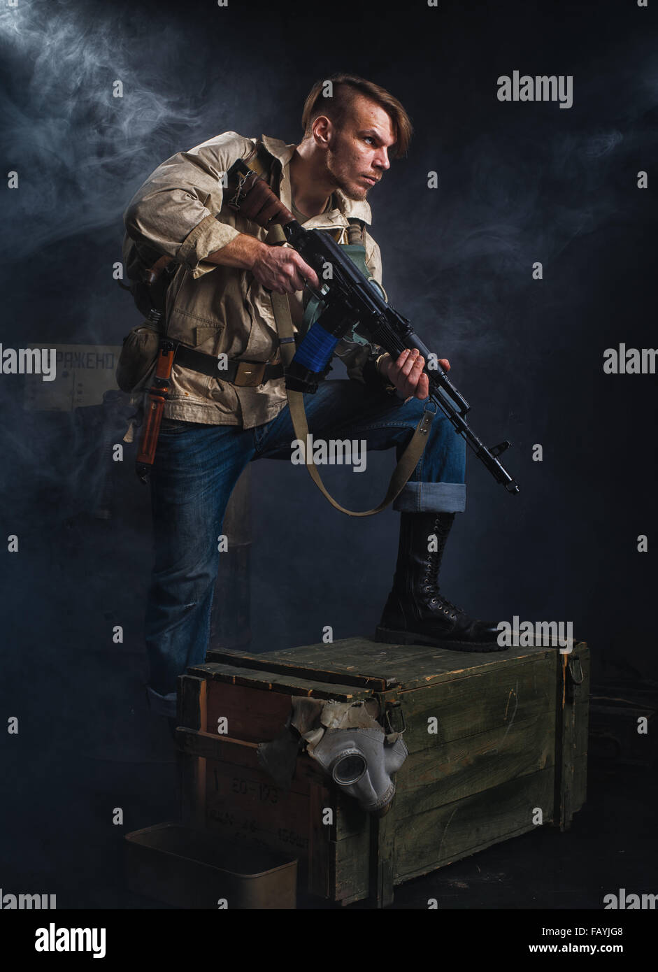 Armed man with a gun. Post-apocalyptic fiction. Stalker. Stock Photo