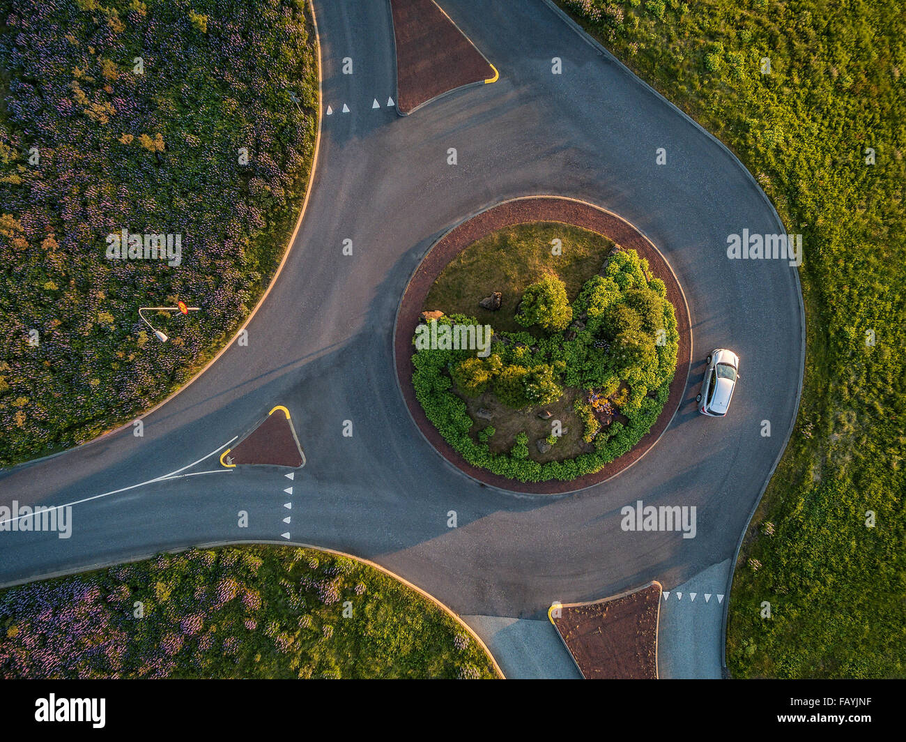 Aerial view-single car in a traffic circle, summertime, Reykjavik, Iceland. Image shot with a drone. Stock Photo