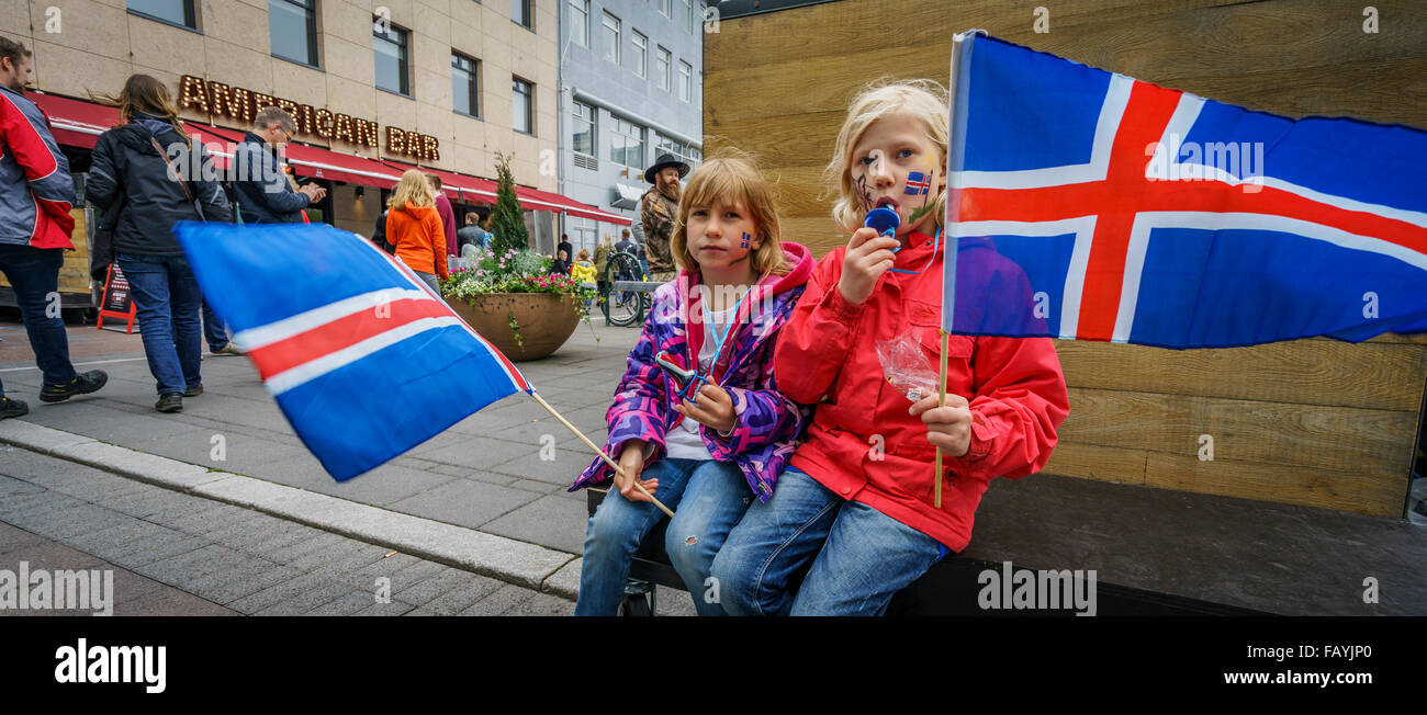 Young girls with Icelandic flags on Independence day, June 17th, Reykjavik, Iceland Stock Photo