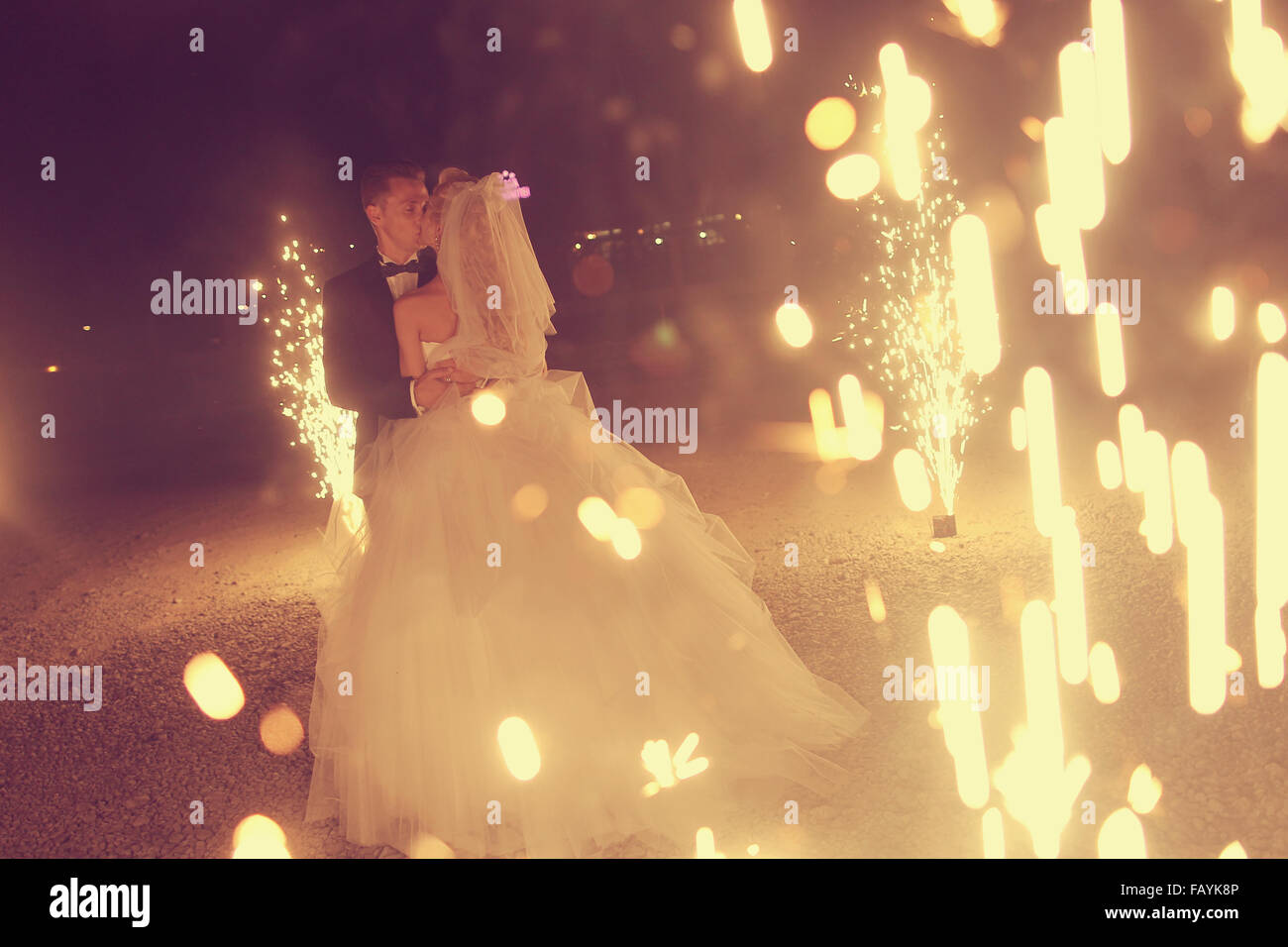 Bridal couple dancing sorrounded by fireworks Stock Photo