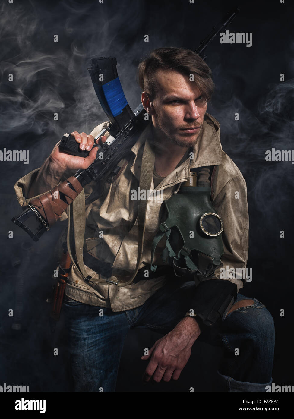 Armed man with a gun. Post-apocalyptic fiction. Stalker. Stock Photo