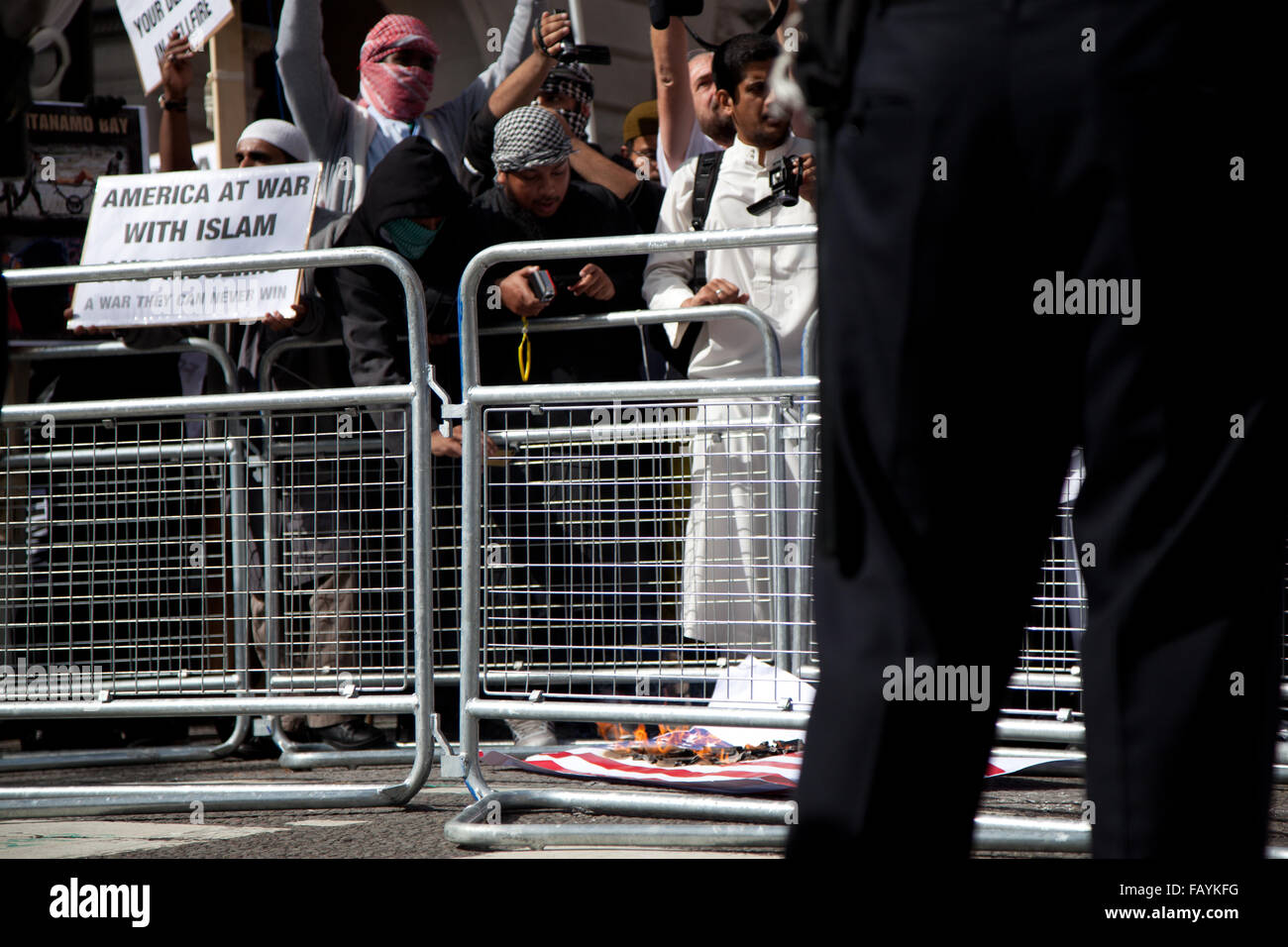 FILE IMAGE - London, UK. 11th Sept, 2011. Siddhartha Dhar films an american flag being burnt whilst attending a 9/11 protest outside US embassy in 2011. Credit:  nelson pereira/Alamy Live News Stock Photo