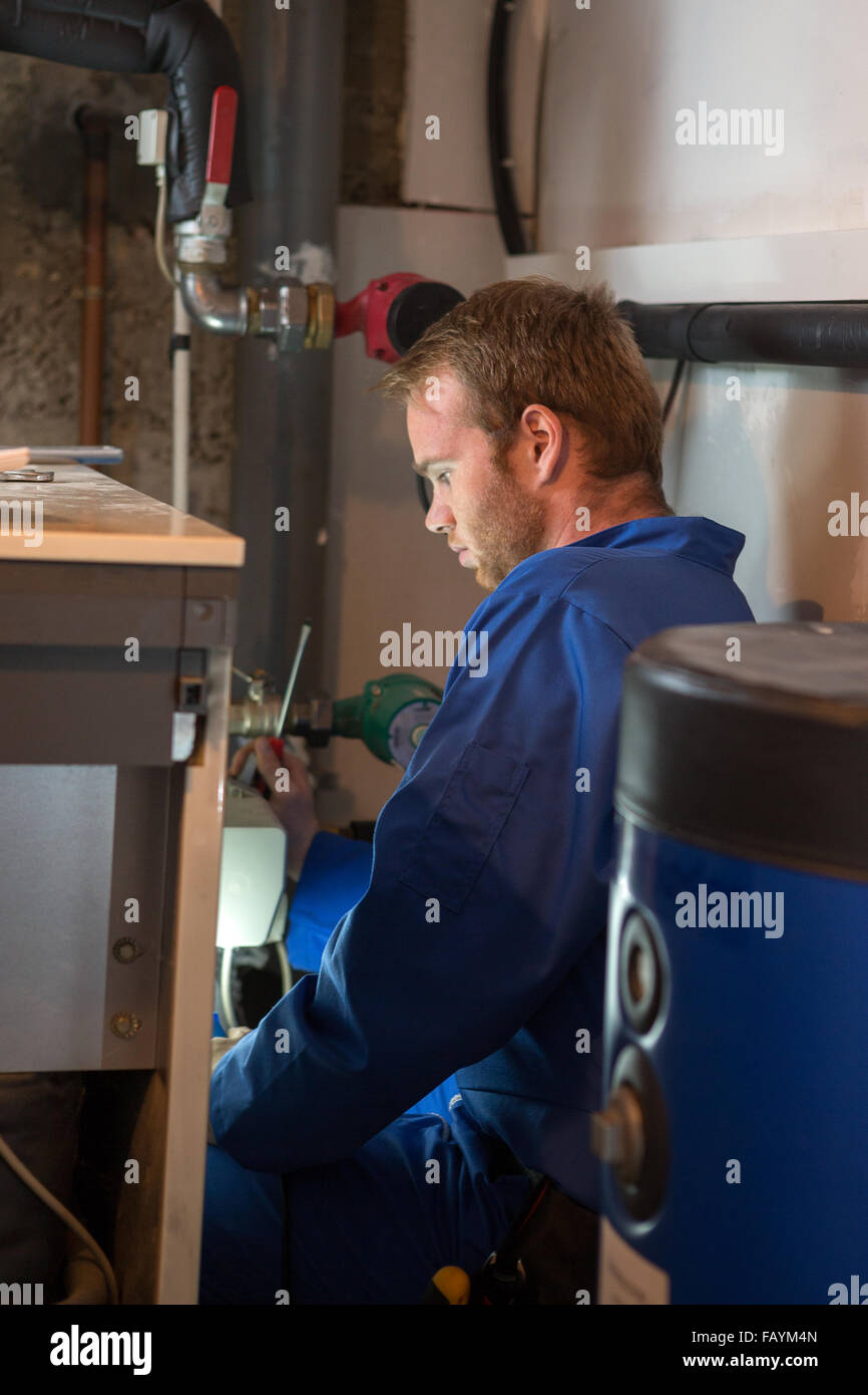 Technician instaling   heating system Stock Photo