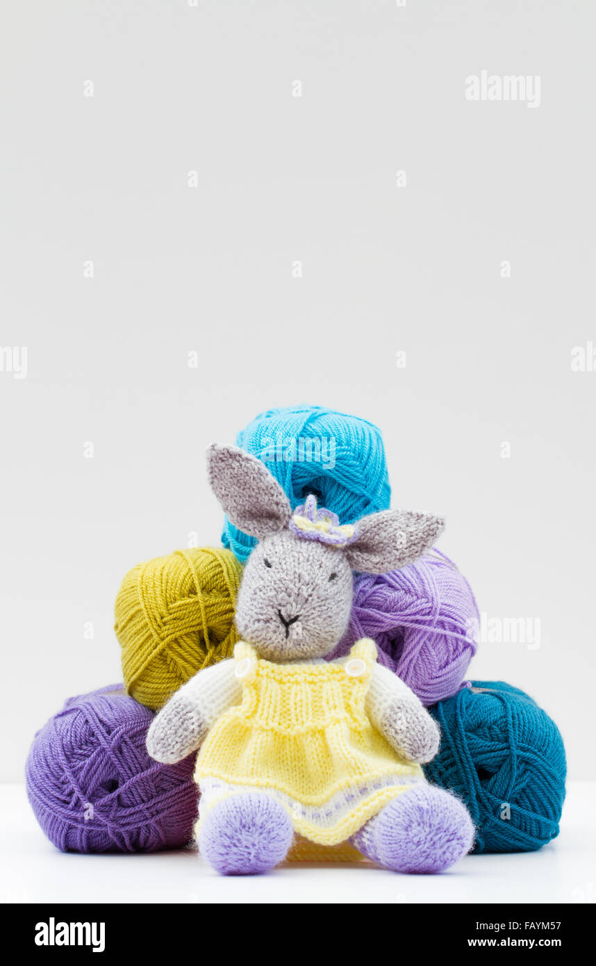 Woolen Rabbit A homemade woolen toy rabbit sitting in front of balls of wool and ...