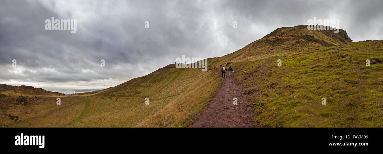 EDINBURGH, SCOTLAND - JANUARY 2ND 2016: Hikers climbing up towards the peak of Arthurs Seat in Holyrood Park, Edinbugh on 2nd Ja Stock Photo