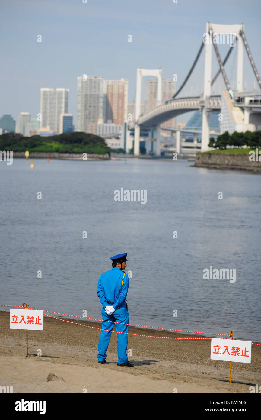 Japanese policeman on Odaiba beach Tokyo bay Stock Photo