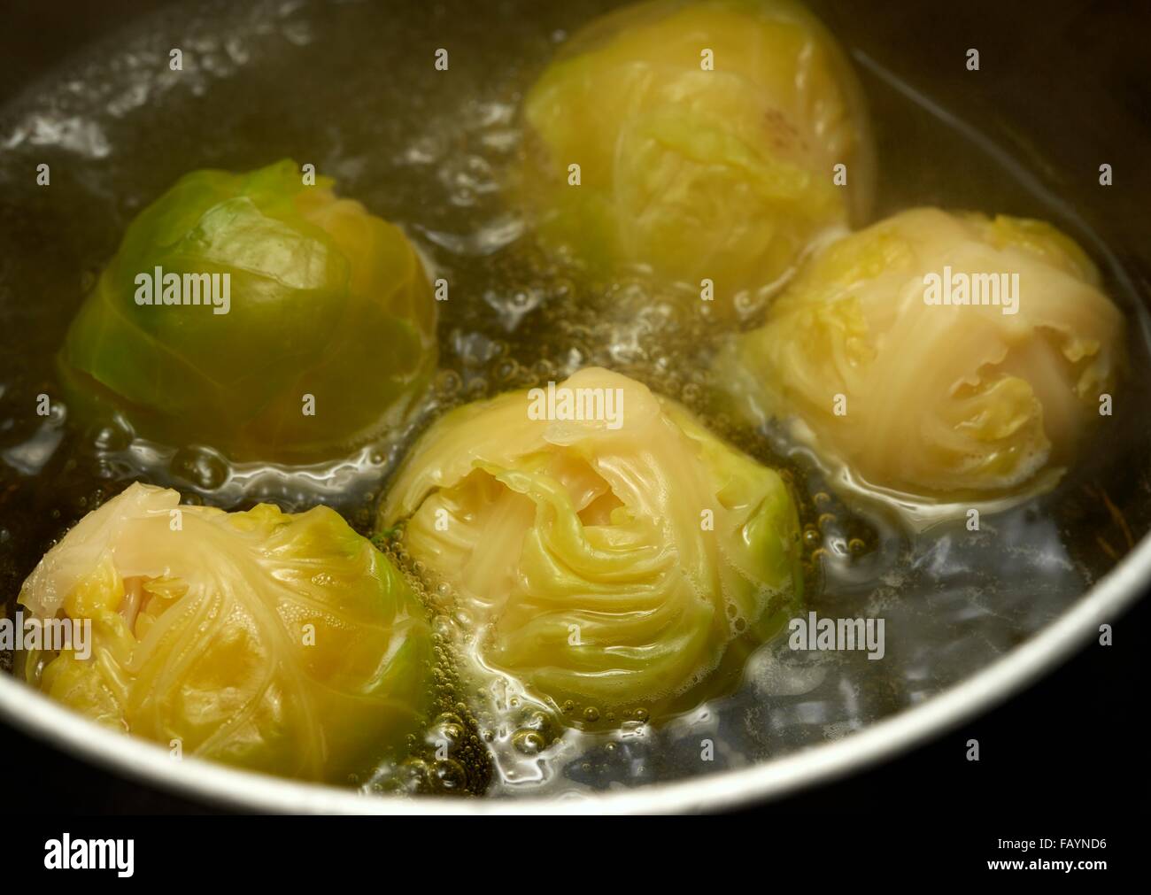 Brussel sprouts boiling in a pan of water Stock Photo