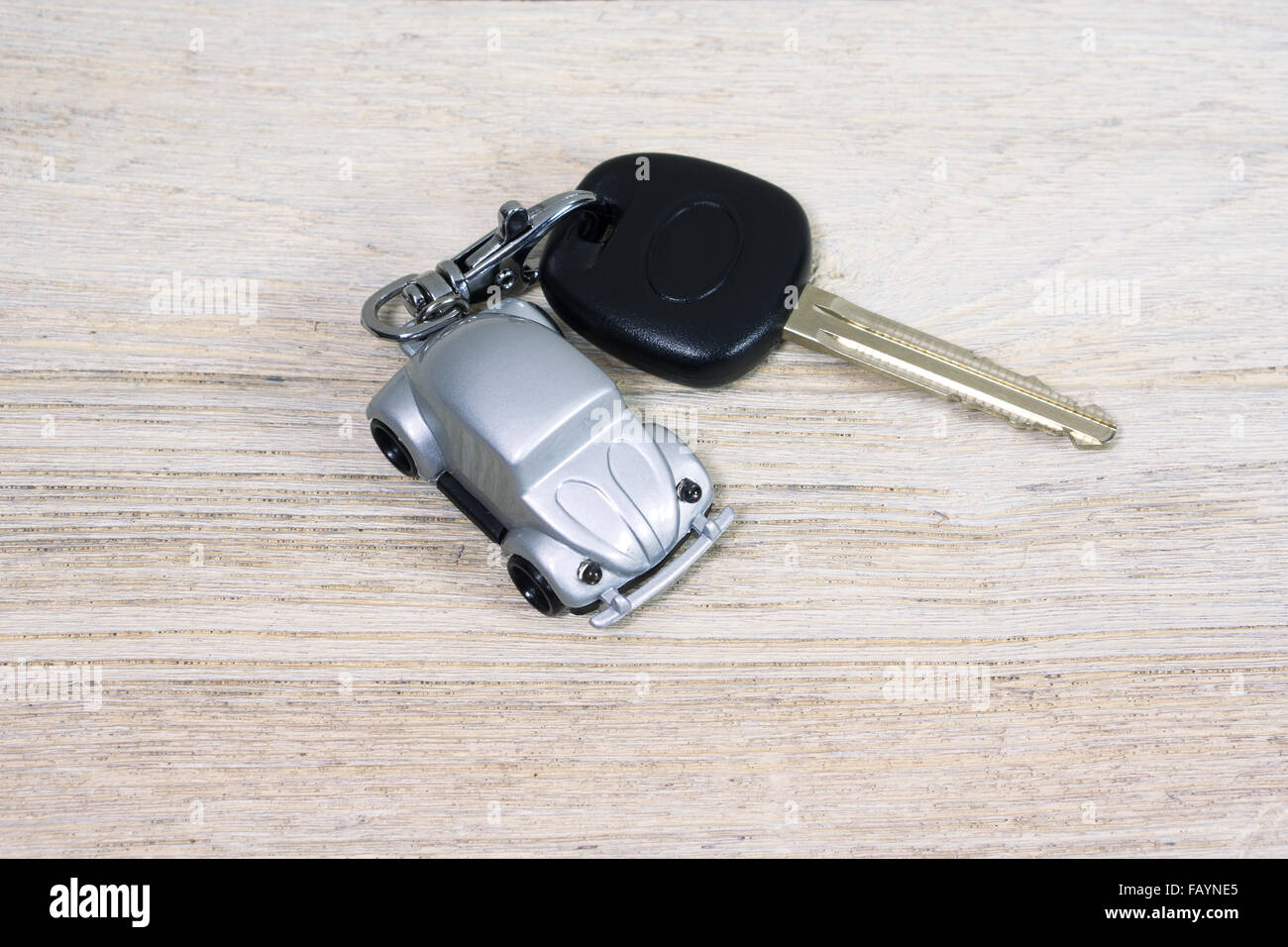Car toy with car key on white wooden table Stock Photo Alamy