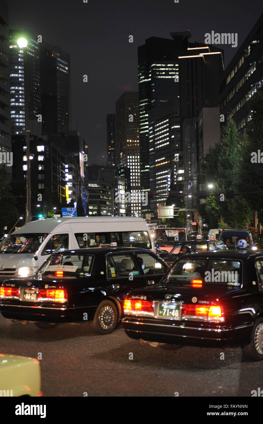 cars in the traffic at night in Shinjuku Tokyo Stock Photo