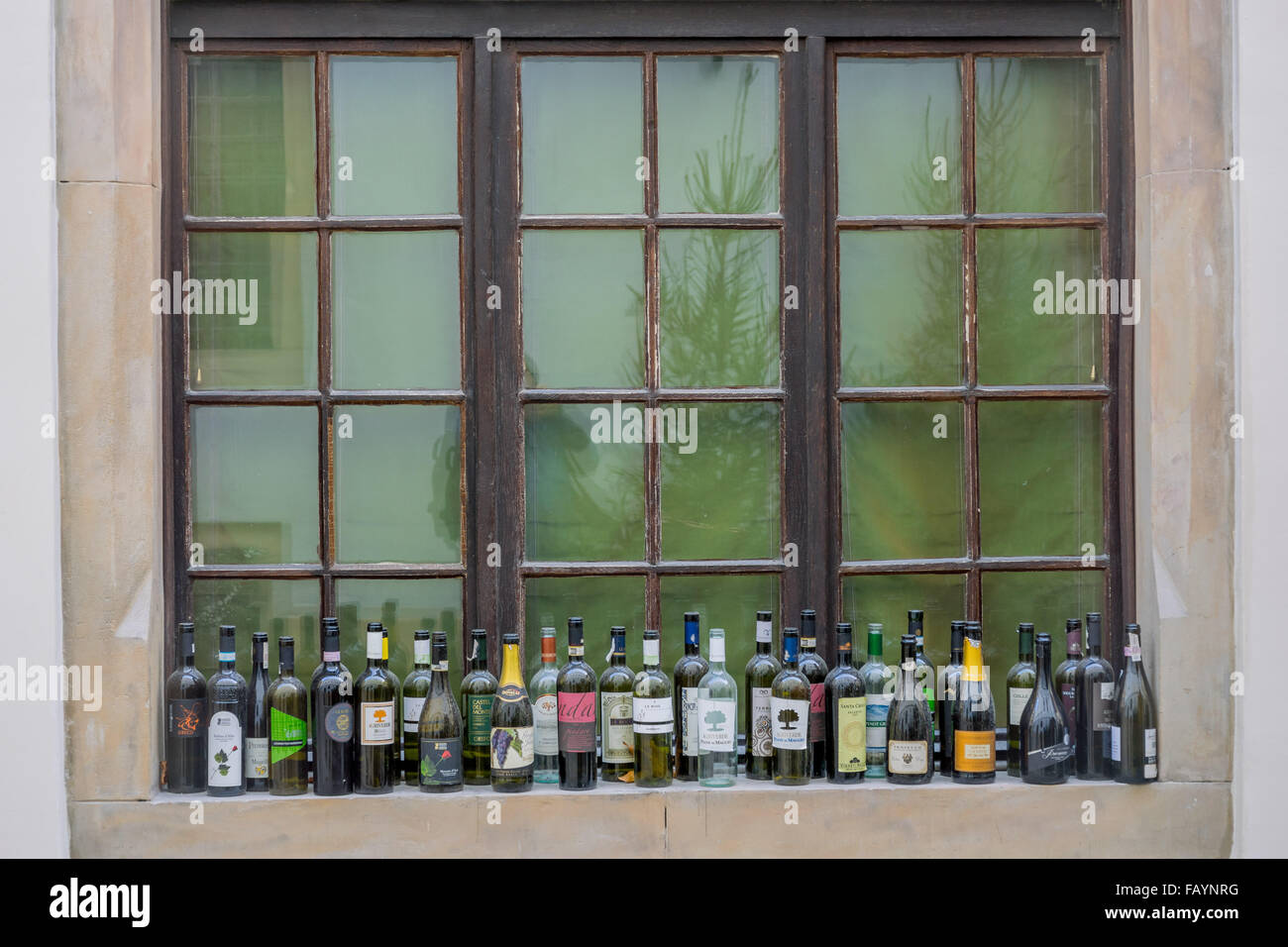 Empty wine bottles standing on the windowsill Stock Photo